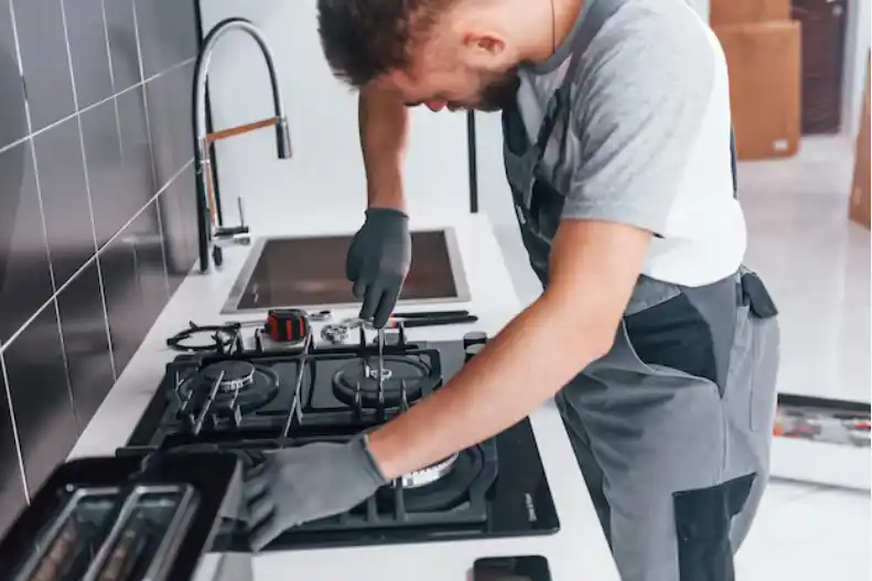 Skilled technician servicing gas stove burner – professional gas stove repair and maintenance